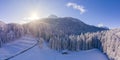 Wonderful winter forest landscape with sunbeams