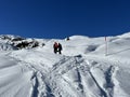 Wonderful winter hiking trails and traces in the fresh alpine snow cover of the Swiss Alps and over the tourist resort of Arosa