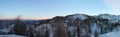 Wonderful winter panoramic view on snowy mountains in sunset blue sky Royalty Free Stock Photo