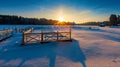 Winter sunrise over a snow-covered lake and a wooden pier Royalty Free Stock Photo