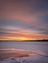 Wonderful winter sunset above the frozen lake, vertical background Royalty Free Stock Photo