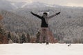 Wonderful youg women in ski clothes enjoy a freedom in alps. She takes a deep breath and exhales air from the mountains.