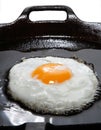 Wonderfull frying egg with oil in cast-iron pan Royalty Free Stock Photo