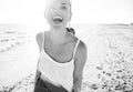 Smiling young woman on beach in evening having fun time Royalty Free Stock Photo