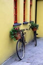 Wonderfully nostalgic scene of two rustic bikes propped against yellow stone building