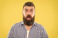 Wondering every time. Man bearded hipster wondering face yellow background close up. Guy surprised face expression