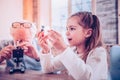 Wondering girl viewing at unknowing chemical equipment Royalty Free Stock Photo