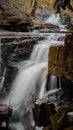 Wonderous waterfall in rocks in a fall forest