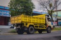 Classic Mitsubishi canter dump truck driving fast on the road during rainy day