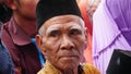 The typical face of an old Javanese Muslim man at a religious event. Focus selected