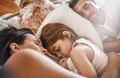 She wont be leaving their bed soon. a family sleeping in bed at home. Royalty Free Stock Photo