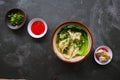 wonton soup or pangsit or dumplings soup and vegetable. wonton is traditional Chinese food of minced meat wrapped in flour sheets Royalty Free Stock Photo