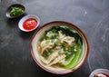 wonton soup or pangsit or dumplings soup and vegetable. wonton is traditional Chinese food of minced meat wrapped in flour sheets Royalty Free Stock Photo
