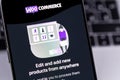 WooCommerce (Woo) logo on a screen smartphone iPhone closeup. WooCommerce is an open-source e-commerce plugin