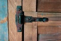 Door Latch Closeup aged door with rusty latch - closeup. Planks, pattern. Royalty Free Stock Photo