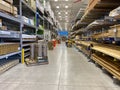 The wood aisle at Lowes home improvement store with stacks of lumber waiting for customers to purchase