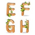 Wood alphabet with branch green leaves Royalty Free Stock Photo