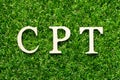 Wood letter in word CPT Abbreviation of Carriage Paid To on green grass background Royalty Free Stock Photo