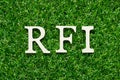 Wood letter in word RFI Abbreviation of request for information on green grass background