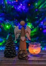 Wood angel, glass candle light, cone and christmas tree on wood table. Decoration background Royalty Free Stock Photo