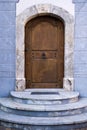 Wood Arch Door on Blue Stone Building Royalty Free Stock Photo