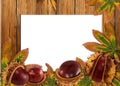 Wood background with autumn chestnuts and leaves Royalty Free Stock Photo