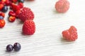 Wood background. Freshly picked blueberries, raspberries and wild strawberries Royalty Free Stock Photo