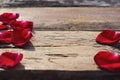 Wood background texture decorated with elegant red rose petals decoration with empty space for text Royalty Free Stock Photo