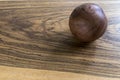 Wood ball on a wood table in studio