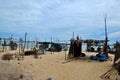 Wood and bamboo palm leaf shacks by seaside in fishing village Pattani Thailand