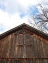 1891 wood barn gable rooftop with intricate window cornice detail Royalty Free Stock Photo