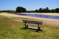 Wood bench empty in Ares lake sand wild beach calm water in gironde france