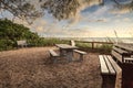 Wood bench overlooks White sand path leading toward Delnor Wiggins State Park