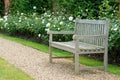 Wood bench in rose garden Royalty Free Stock Photo