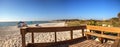 Wood bench on the white sand beach of Delnor-Wiggins Pass State