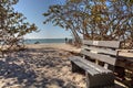 Wood bench on the white sand beach of Delnor-Wiggins Pass State