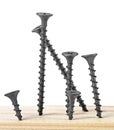 Wood black screws on wooden background, isolated image Royalty Free Stock Photo