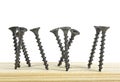 Wood black screws on wooden background, isolated image Royalty Free Stock Photo