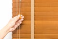 Wood blinds closed by hand.