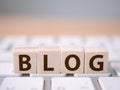 Wood block cube on computer keyboard with word BLOG Royalty Free Stock Photo