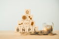 wood block with icon BNPL with online shopping icons blurred coins. Buy now pay later online shopping concept Royalty Free Stock Photo