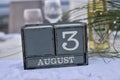 Wood blocks in box with date, day and month 3 August
