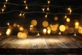 wood board table in front of Christmas warm gold garland lights on wooden rustic background Royalty Free Stock Photo