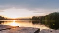 wood board table in front of sanset landscape of sparkling lake water. background is blurred. Royalty Free Stock Photo