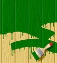 Wood boards painted in green color with a paint brush