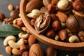 Wood bowl with different tasty nuts on gray wooden background Royalty Free Stock Photo