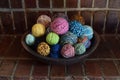 Wood bowl filled with colorful balls of hand spun wool yarn