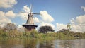 Wood and brick old fashioned Dutch Windmill along a canal