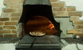 Wood-fired oven with pizza