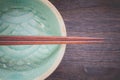 Wood brown chopsticks and celadon green ceramic Royalty Free Stock Photo